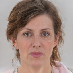 Joyful white adult female with medium  brown hair and grey eyes