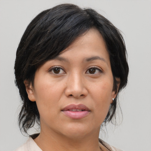 Joyful asian young-adult female with medium  brown hair and brown eyes