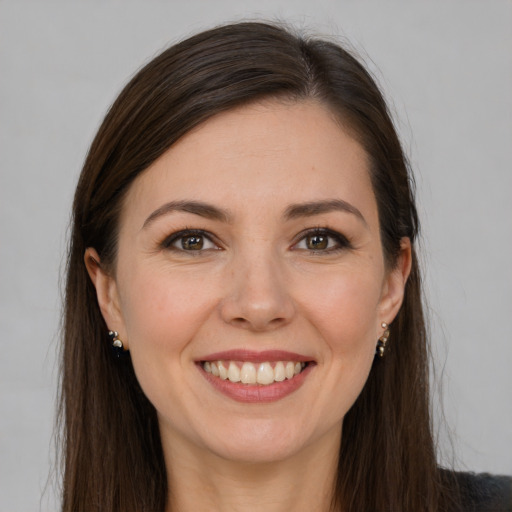 Joyful white young-adult female with long  brown hair and brown eyes