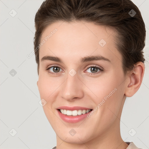 Joyful white young-adult female with short  brown hair and brown eyes