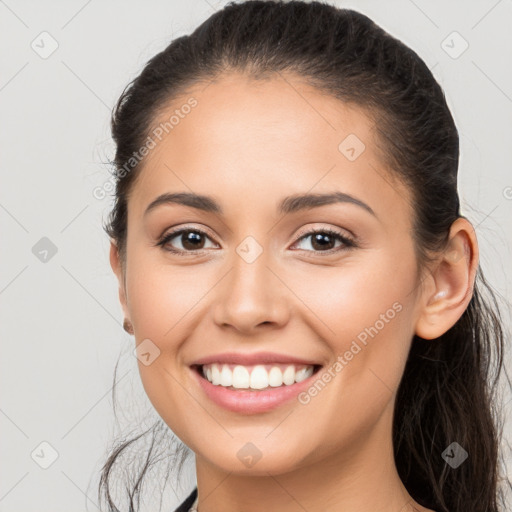 Joyful white young-adult female with long  brown hair and brown eyes