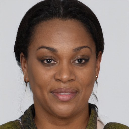 Joyful black adult female with short  brown hair and brown eyes