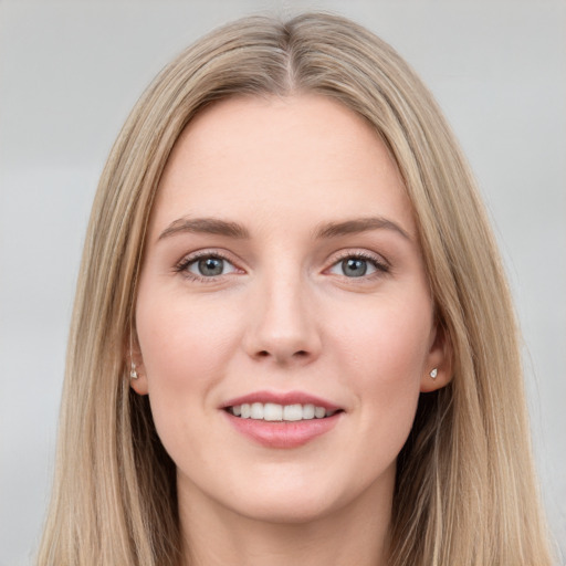 Joyful white young-adult female with long  brown hair and grey eyes