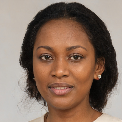 Joyful black young-adult female with medium  black hair and brown eyes