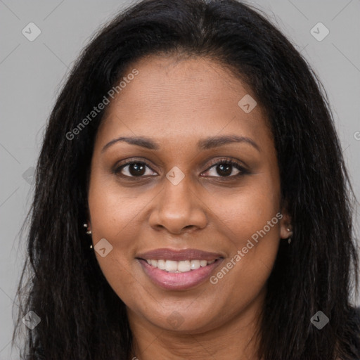 Joyful black young-adult female with long  brown hair and brown eyes