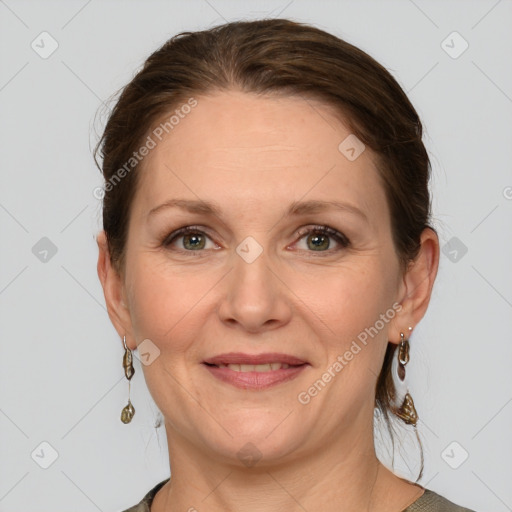 Joyful white adult female with medium  brown hair and grey eyes