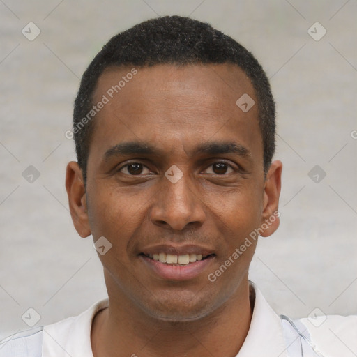Joyful black young-adult male with short  brown hair and brown eyes