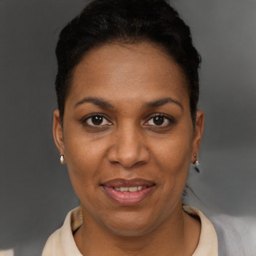 Joyful black adult female with short  brown hair and brown eyes