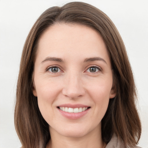 Joyful white young-adult female with long  brown hair and grey eyes