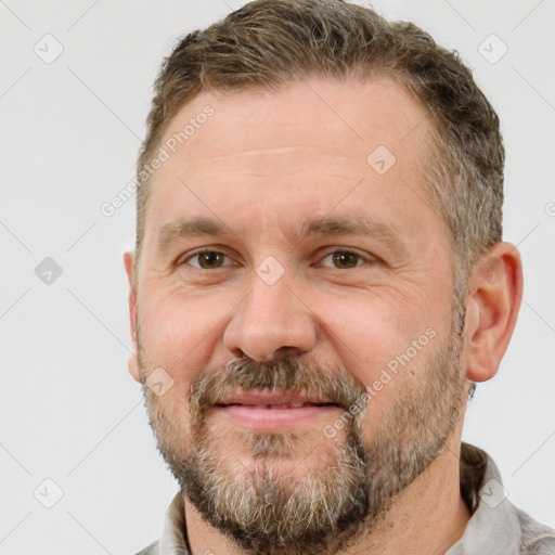 Joyful white adult male with short  brown hair and brown eyes