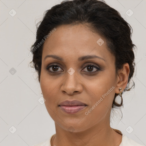 Joyful latino adult female with short  brown hair and brown eyes