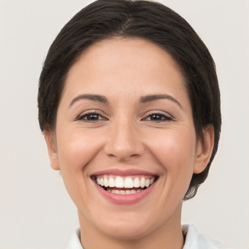 Joyful white young-adult female with short  brown hair and brown eyes