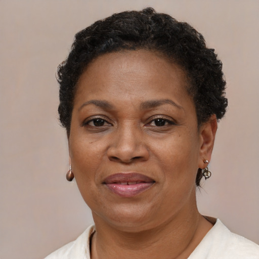 Joyful black adult female with short  brown hair and brown eyes
