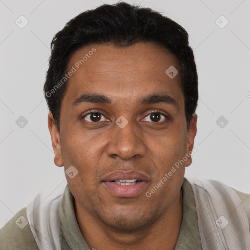 Joyful black adult male with short  black hair and brown eyes