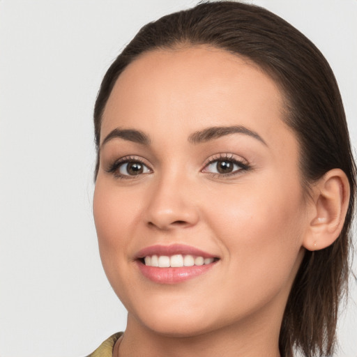 Joyful white young-adult female with long  brown hair and brown eyes