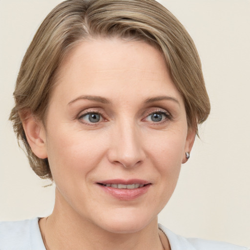 Joyful white adult female with medium  brown hair and grey eyes