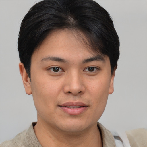Joyful asian young-adult male with short  brown hair and brown eyes