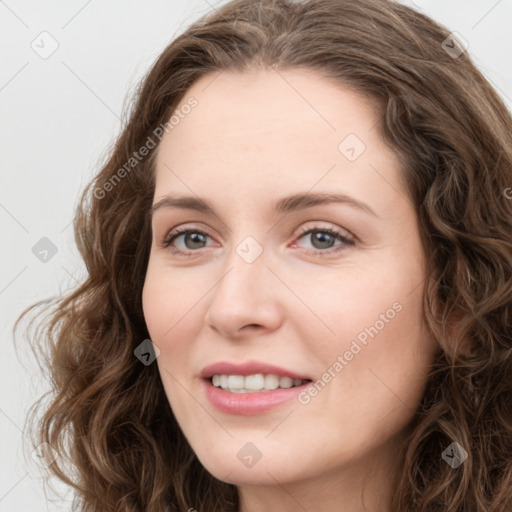 Joyful white young-adult female with long  brown hair and green eyes