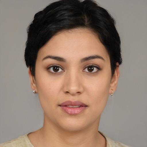 Joyful latino young-adult female with short  black hair and brown eyes