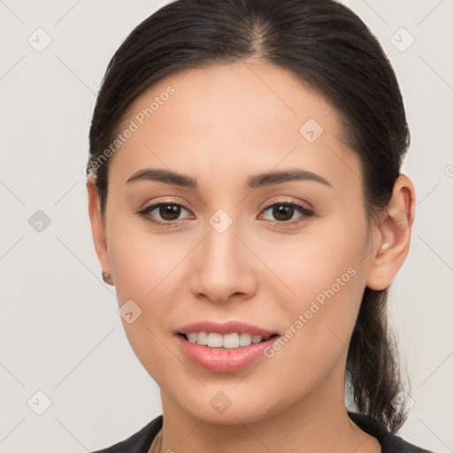 Joyful white young-adult female with long  brown hair and brown eyes