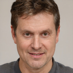 Joyful white adult male with short  brown hair and grey eyes