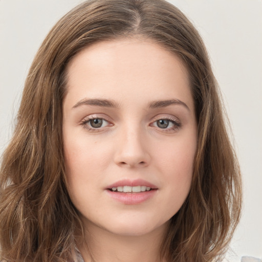 Joyful white young-adult female with long  brown hair and green eyes