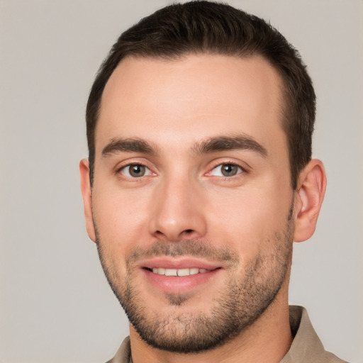 Joyful white young-adult male with short  brown hair and brown eyes