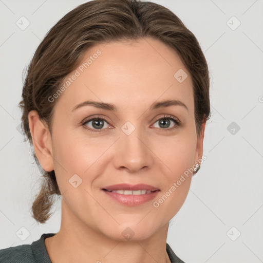 Joyful white young-adult female with medium  brown hair and grey eyes