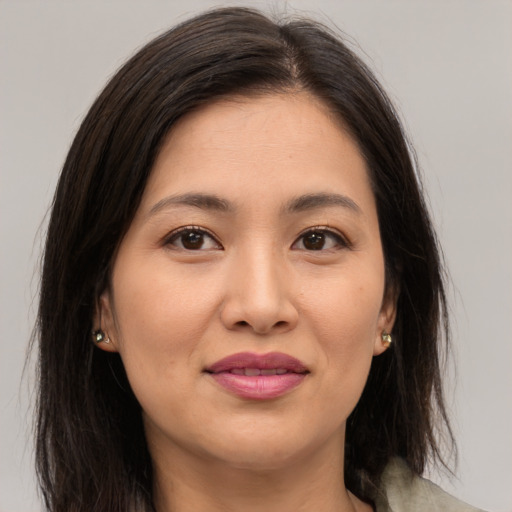 Joyful asian young-adult female with long  brown hair and brown eyes