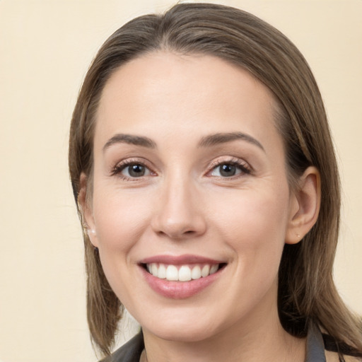 Joyful white young-adult female with medium  brown hair and grey eyes