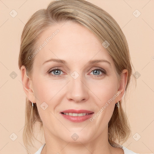 Joyful white adult female with medium  brown hair and blue eyes