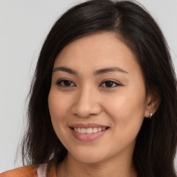 Joyful white young-adult female with long  brown hair and brown eyes