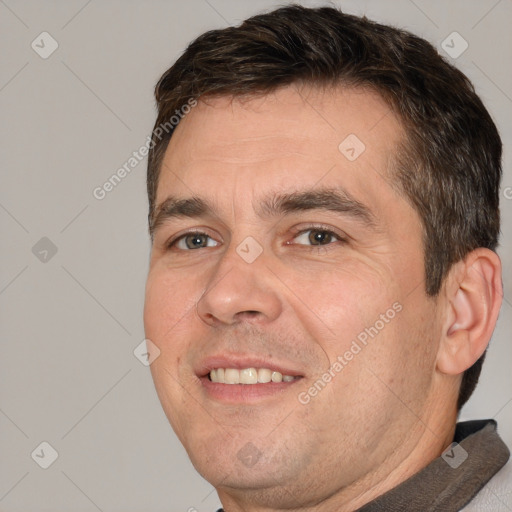 Joyful white adult male with short  brown hair and brown eyes