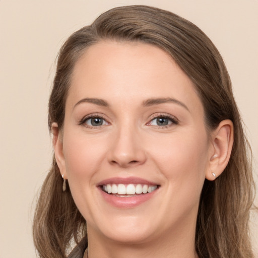 Joyful white young-adult female with long  brown hair and green eyes