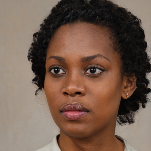 Neutral black young-adult female with medium  black hair and brown eyes