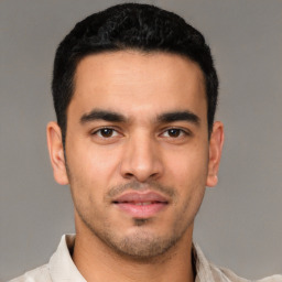 Joyful white young-adult male with short  black hair and brown eyes