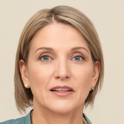 Joyful white adult female with medium  brown hair and grey eyes