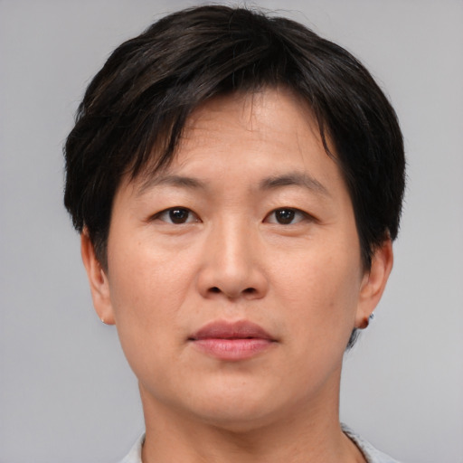Neutral asian adult male with short  brown hair and brown eyes