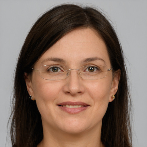 Joyful white adult female with long  brown hair and grey eyes