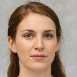 Joyful white young-adult female with medium  brown hair and green eyes