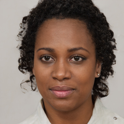 Joyful black young-adult female with medium  brown hair and brown eyes