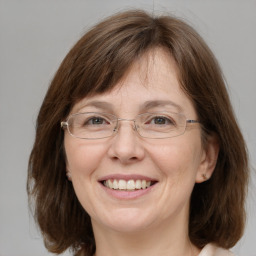 Joyful white adult female with medium  brown hair and grey eyes