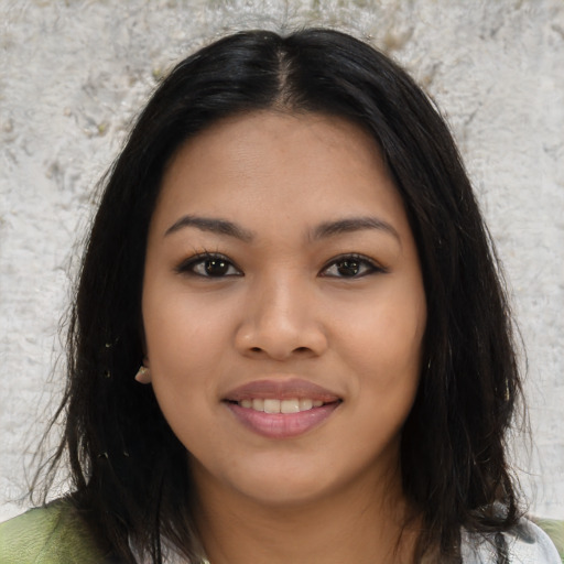 Joyful asian young-adult female with long  brown hair and brown eyes