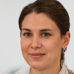 Joyful white adult female with medium  brown hair and brown eyes