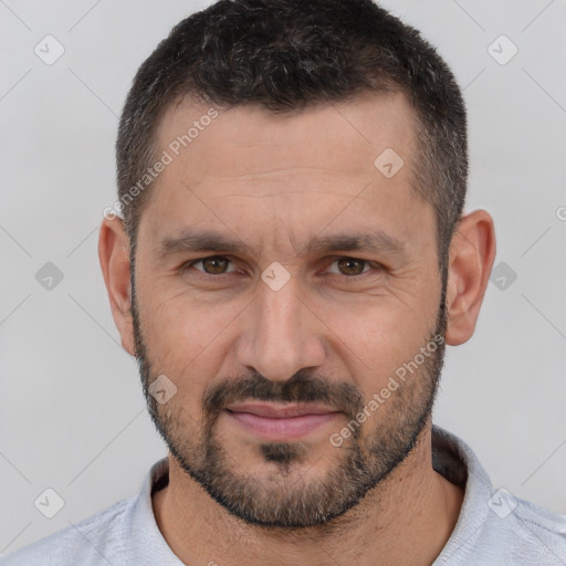 Joyful white adult male with short  brown hair and brown eyes