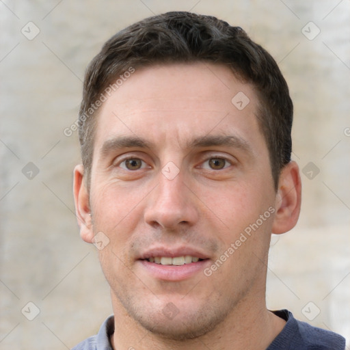 Joyful white young-adult male with short  brown hair and grey eyes