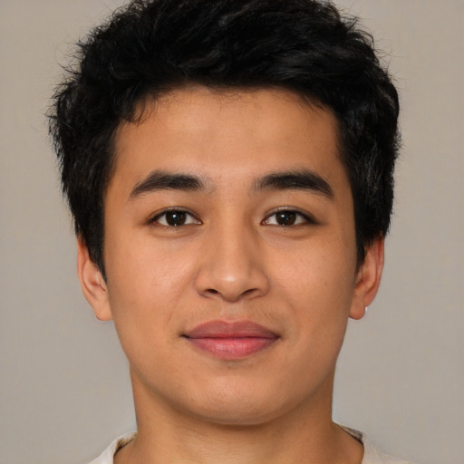 Joyful asian young-adult male with short  black hair and brown eyes