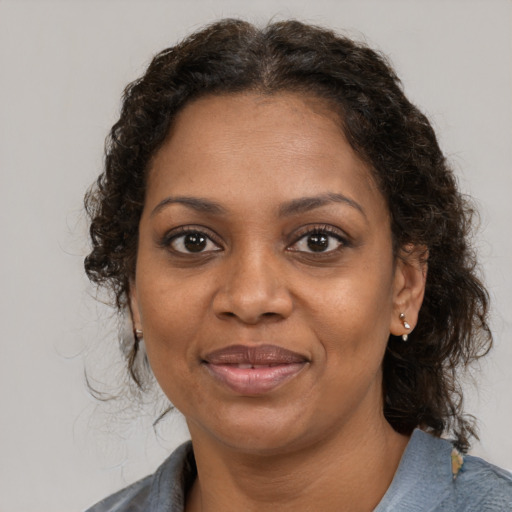 Joyful black young-adult female with medium  brown hair and brown eyes