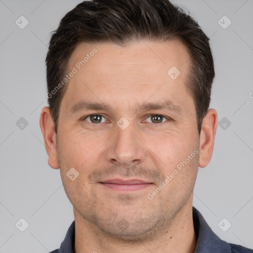 Joyful white adult male with short  brown hair and brown eyes