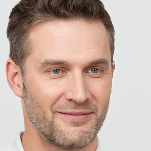 Joyful white adult male with short  brown hair and brown eyes